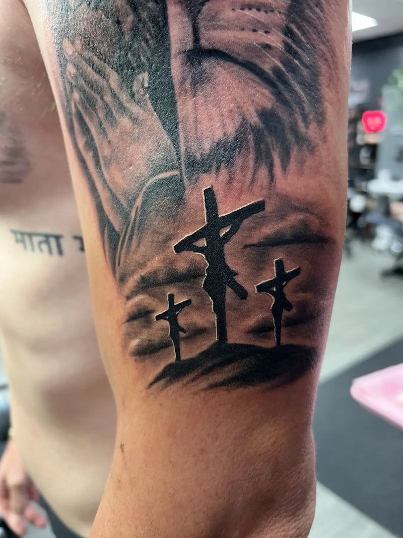Calvary Crosses Arm Tattoo