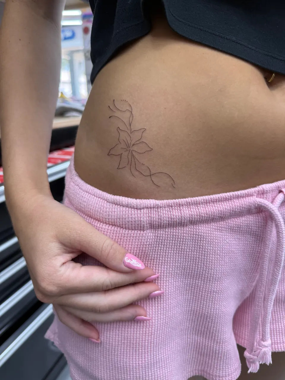 Fine-Line Floral Hip Tattoo