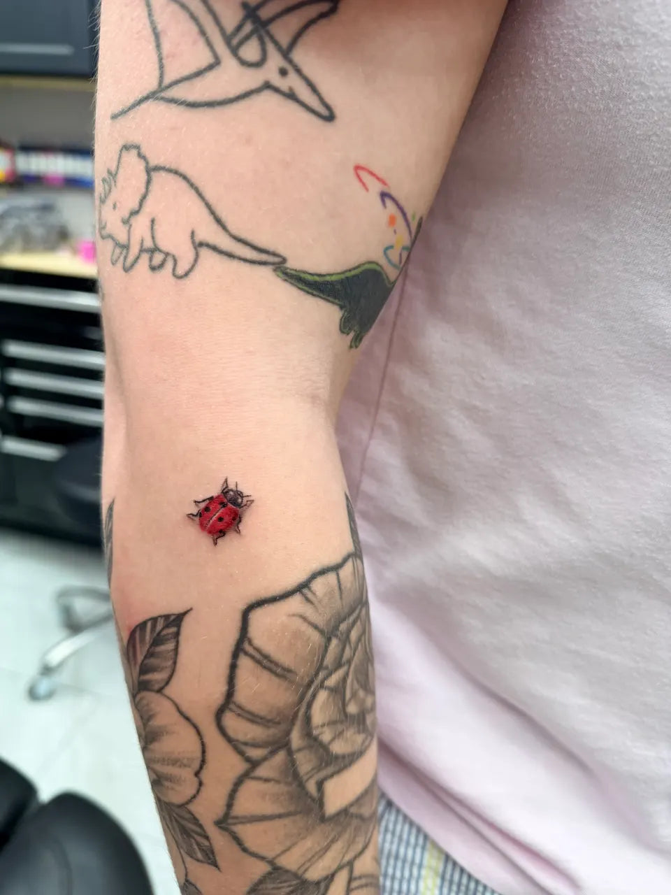 Tiny Realistic Ladybug Tattoo